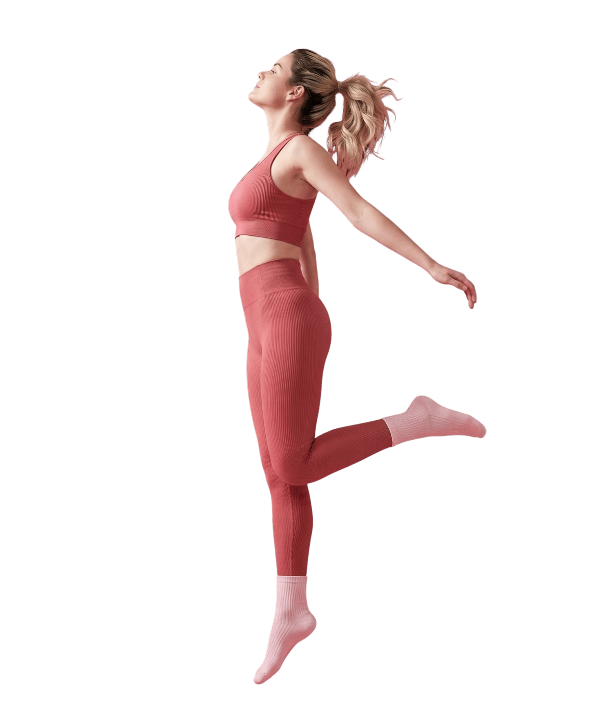 Mujer saltando en atuendo coral - BeU Pilates